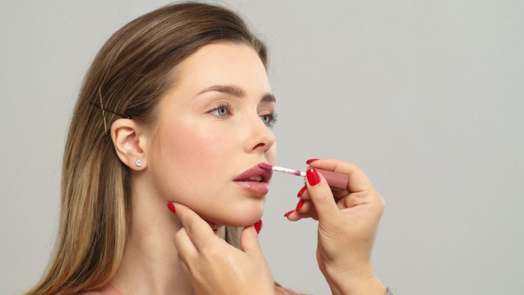 Makeup artist applying lipstick at SPY Salon NCR